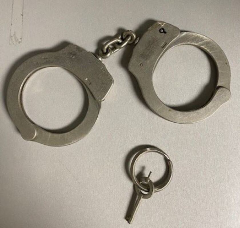 Close up of handcuffs and a key