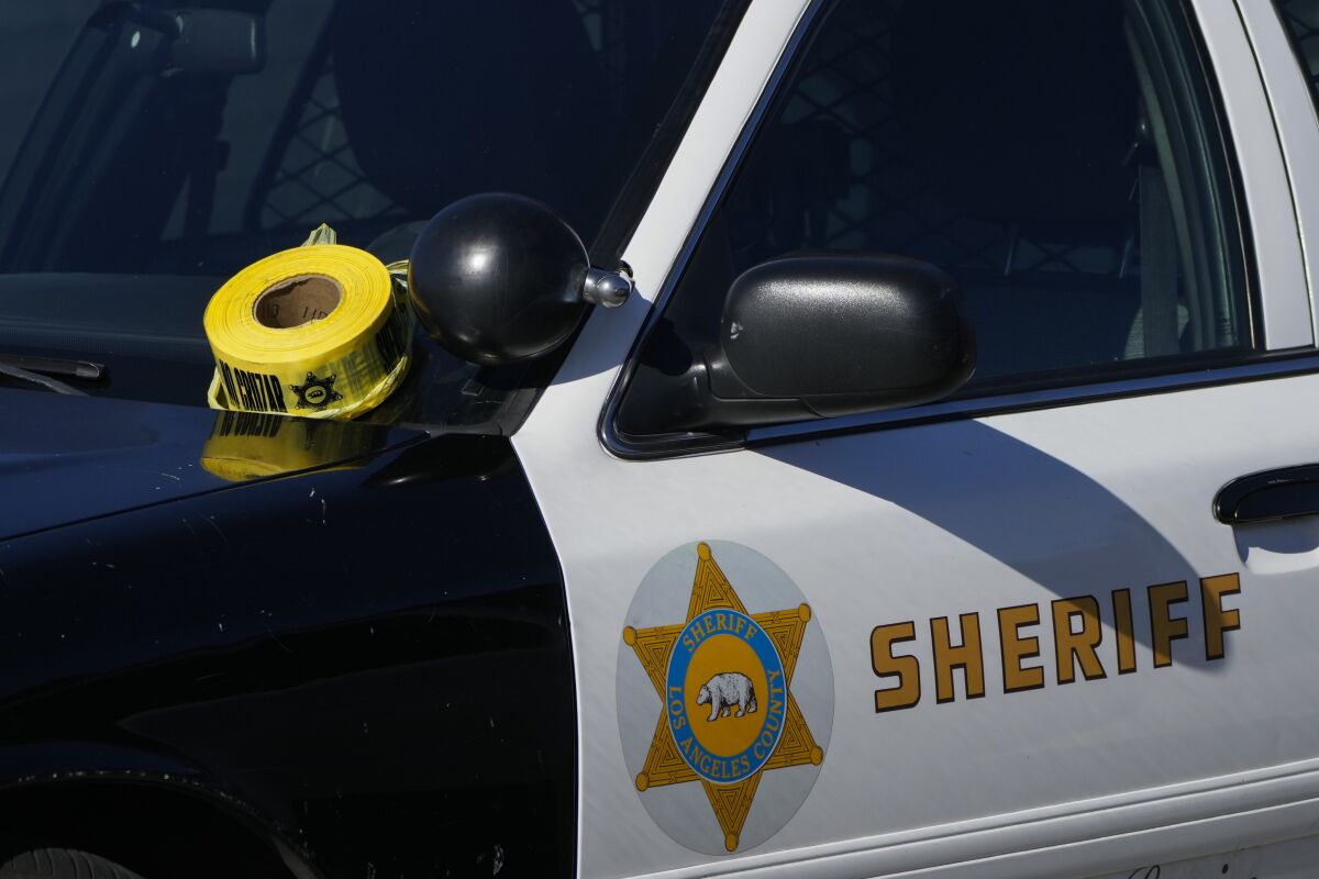 A roll of police tape is left on the windshield of an L.A. County sheriff's vehicle.