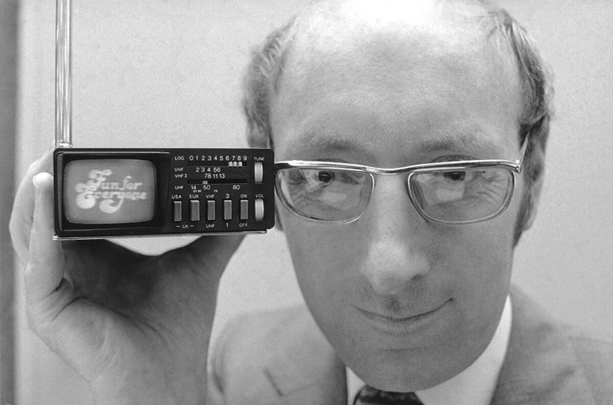 FILE - In this Sept. 18, 1977 file photo, Clive Sinclair, founder of Sinclair Radionics, a New York-based firm, displays the Microvision television in New York. Sinclair, the British inventor and entrepreneur who arguably did more than anyone else to inspire a generation of children into a life-long passion for computers and gaming, has died. He was 81. Sinclair, who rose to prominence in the early 1980s with a series of affordable home computers that offered millions their first glimpse into the world of coding as well as the adrenaline rush of playing games on screens, died on Thursday, Sept. 17, 2021 morning after a long illness with cancer. (AP Photo/Dave Pickoff, File)