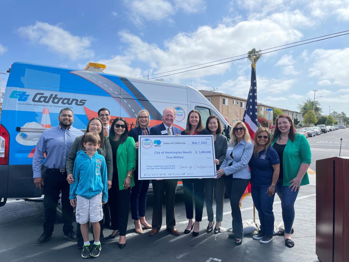 Huntington Beach city officials receive a $5-million check from the California Department of Transportation.