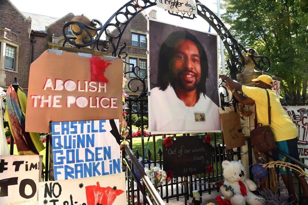 A woman tends to a memorial for Philando Castile