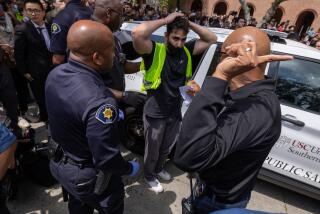 Los Angeles, CA - April 24: Pro-Palestinian demonstrator is released after being taken into custody at USC on Wednesday, April 24, 2024 in Los Angeles, CA. (Brian van der Brug / Los Angeles Times)