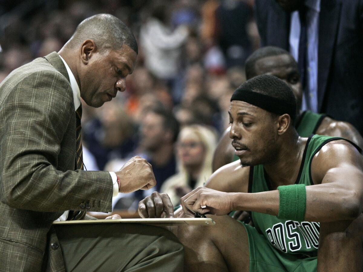Coach Doc Rivers and guard Paul Pierce work on a play during a Celtics timeout in the 2008 playoffs. Could they be reunited in Los Angeles?
