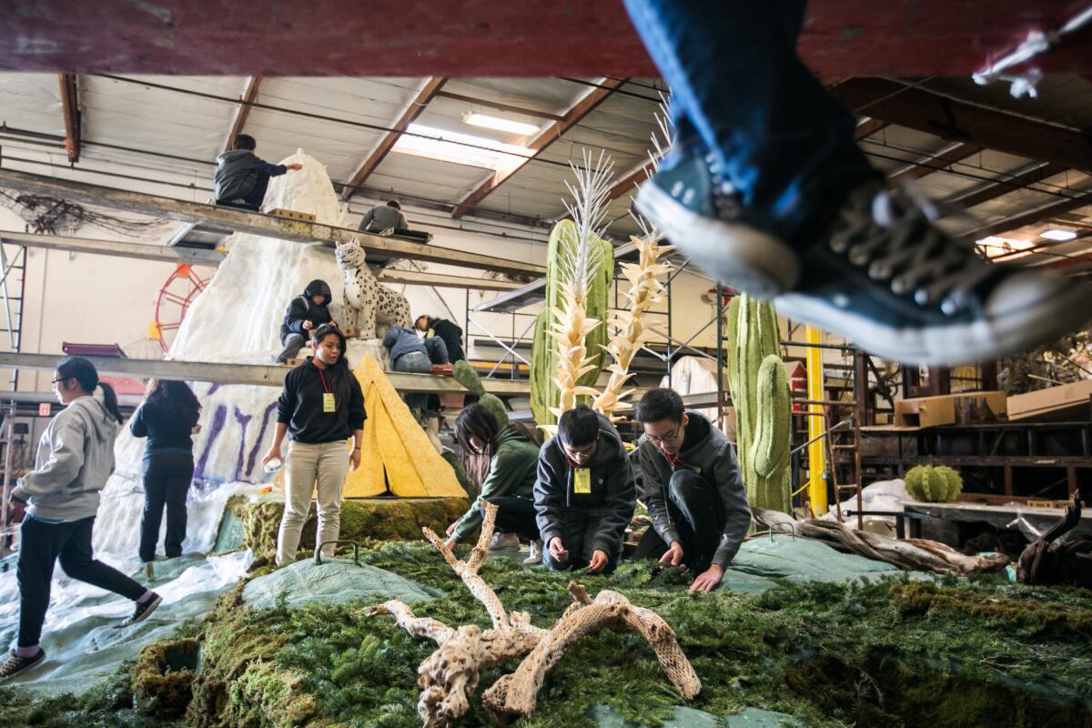 Students from Arroyo High School decorate the Kiehl's Rose Parade float in Irwindale.