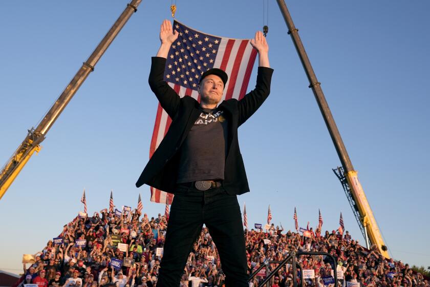 Tesla and SpaceX CEO Elon Musk walks to the stage to speak alongside Republican presidential nominee former President Donald Trump at a campaign event at the Butler Farm Show, Saturday, Oct. 5, 2024, in Butler, Pa. (AP Photo/Alex Brandon)