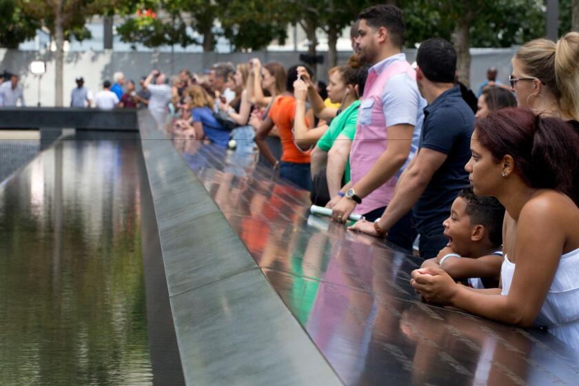 Visitors look at the waterfalls at the World Trade Center Memorial on Sept. 9 in New York.