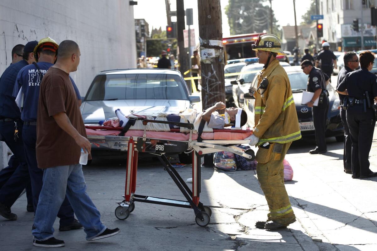 A young boy is transported to an ambulance after a car driven by an elderly driver ran into a group of children and adults near a South Los Angeles school in 2012. The incident was among several that have fanned discussions about older drivers and public safety.