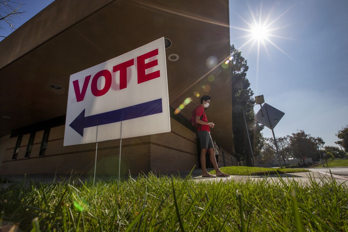 Cody Abril, of Fullerton, exits after voting early in the General Election at California State University.