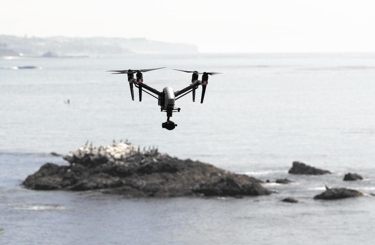 Licensed drone pilot John Barrett flies his professional model camera drone above Rockpile Beach in Laguna Beach on Friday.