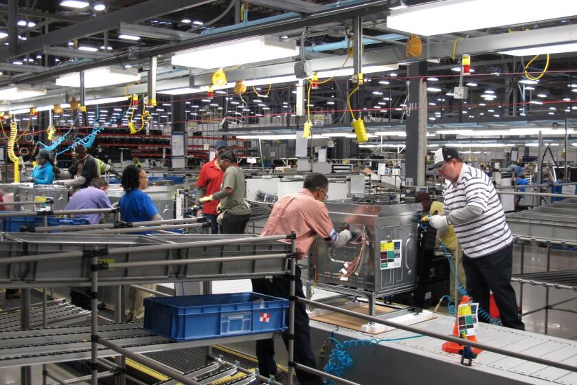 U.S. manufacturing activity slowed last month, dragged down by a drawdown of inventories and poor weather, the Institute for Supply Management said Monday. Above, workers assemble ovens at an appliance factory in Memphis, Tenn., last month.