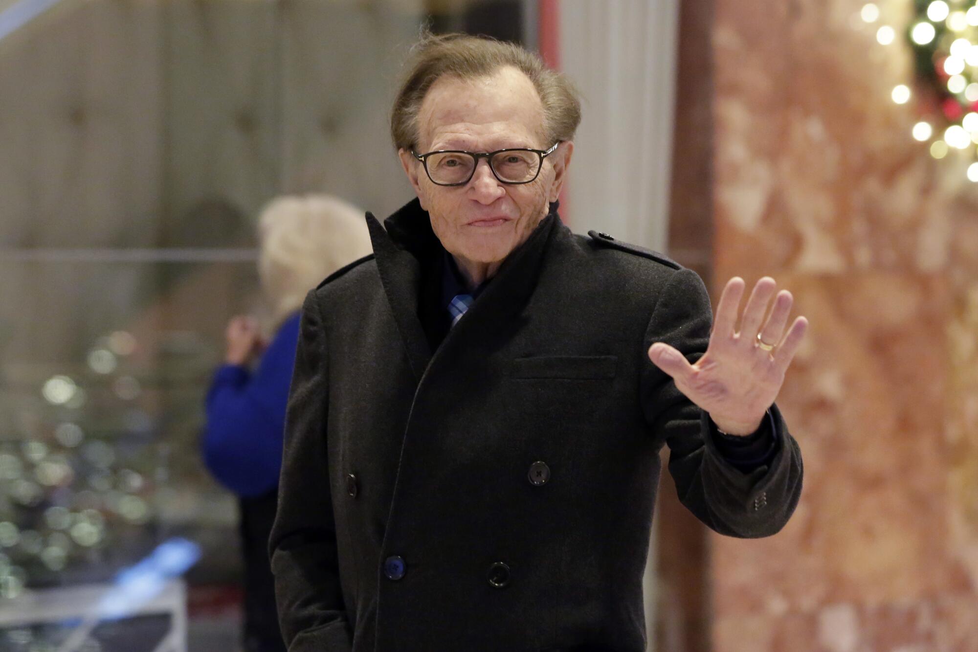 Larry King waves while arriving at Trump Tower in New York on  Dec. 1, 2016.