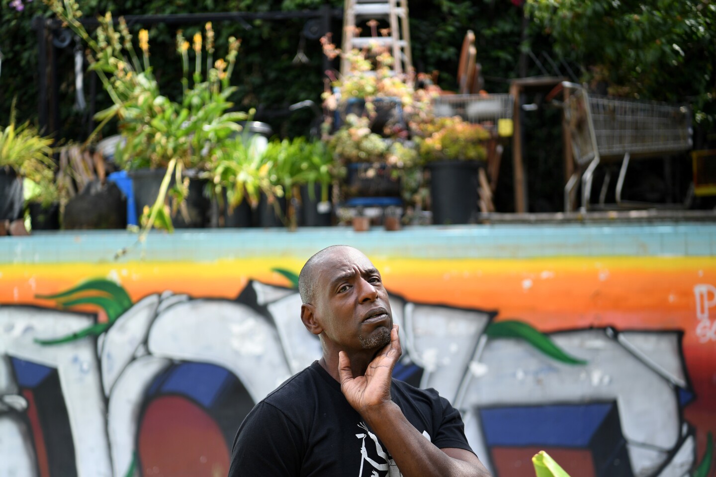 Ron Finley, a.k.a. the Gangsta Gardener, surveys the edible garden he created out of an Olympic-sized pool in his South Los Angeles home.