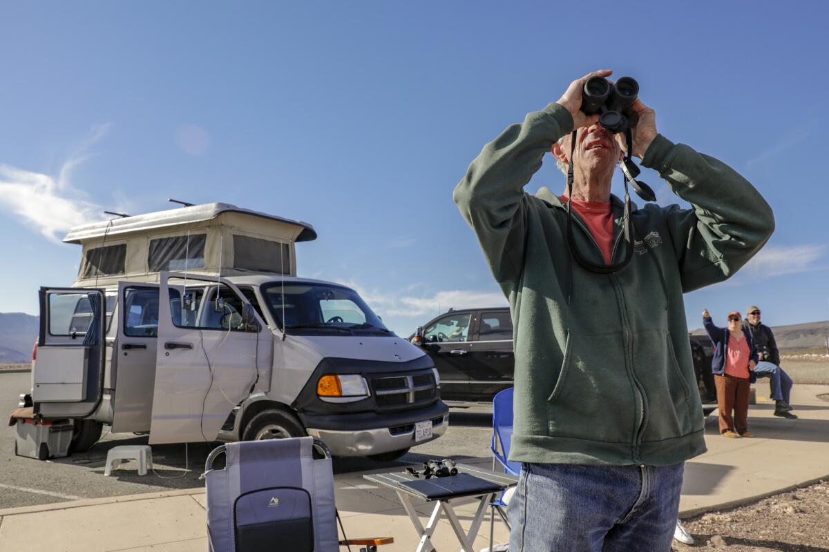 DEATH VALLEY, CA, MARCH 18, 2019 --- Richard, 71, and Candace Campbell, 68, , of Pacific Cove, look for military aircraft with their eyes peeled to sky and ears focused on flight chatter coming from two scanners hanging from camper door. Campbells, parked at Father Father Crowley look out point on I-90, have been making the eight hour trek, in there 2001 Dodge 2500 cargo van that was converted to a camper, to Rainbow Canyon to watch fighter jets blast through the gorge. (Irfan Khan / Los Angeles Times)