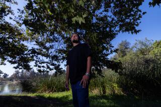 El Monte, CA - August 27: Michael Isaac Yabara, a young climate change activist, stands for portraits at Whitter Narrows on Tuesday, Aug. 27, 2024 in El Monte, CA. (Brian van der Brug / Los Angeles Times)