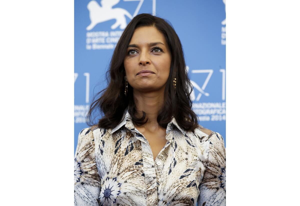 FILE - Jhumpa Lahiri poses during a photo call at the 71st edition of the Venice Film Festival in Venice, Italy, on Aug. 27, 2014. Princeton University Press announced Monday that Lahiri’s “Translating Myself and Others” will come out in May. (AP Photo/Andrew Medichini, File)