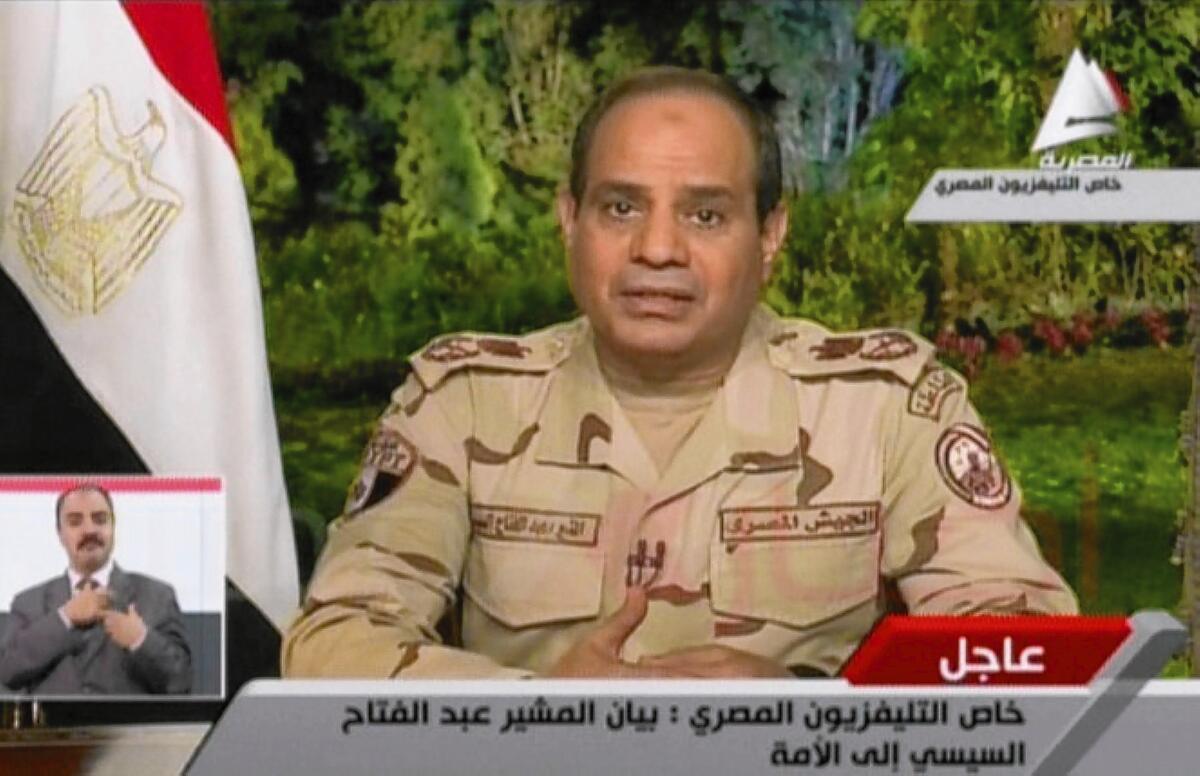 In Cairo, Abdel Fattah Sisi announces his resignation from his military position so he can run in the upcoming Egyptian presidential election, in an image taken from television.