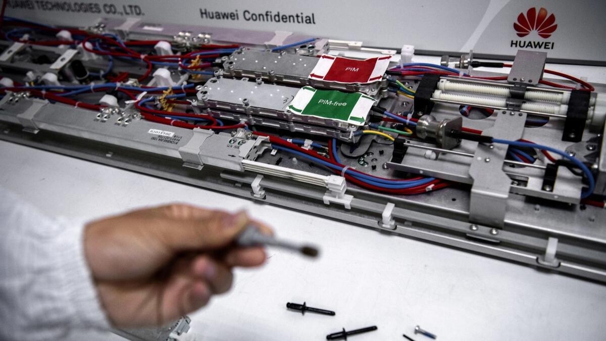 A Huawei engineer displays parts in the research and development area of the Bantian campus in Shenzhen, China.