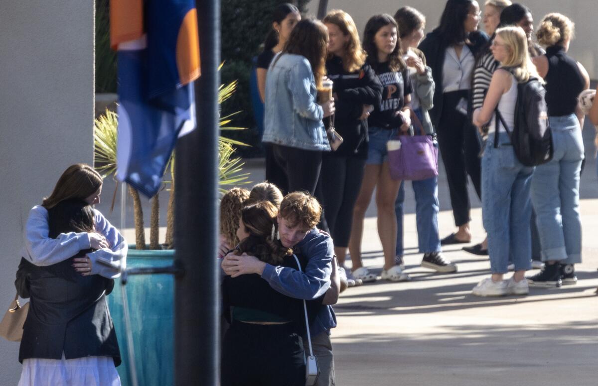 Pepperdine University students embrace one another before a vigil.