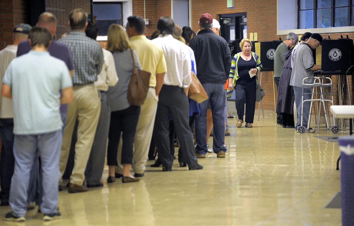 Voters line up Tuesday at Paschal High School in Fort Worth, Texas. Texas is among the states implementing voter identification laws this election.