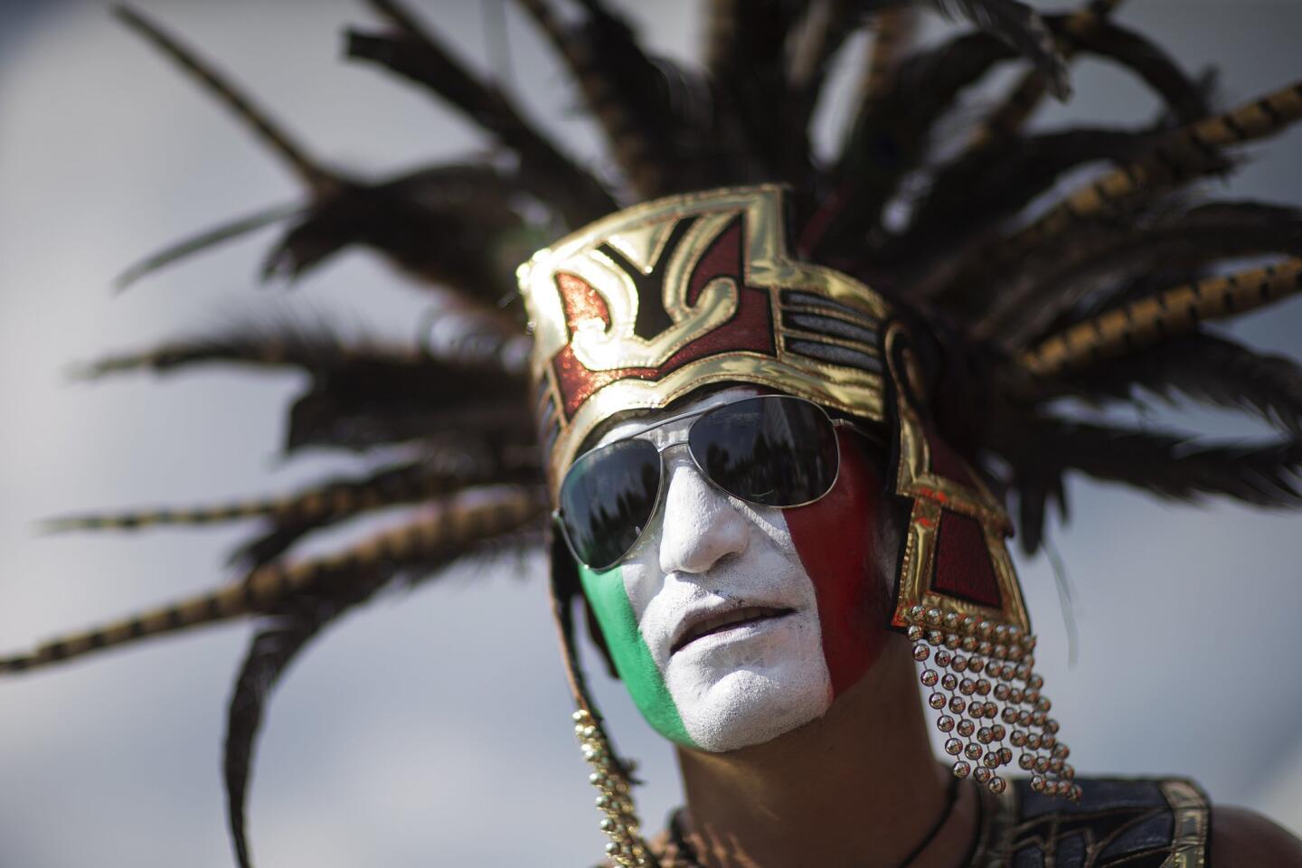 Luis Angel, of Jackson, Miss., is dressed up as an Aztec Indian before the start of the CONCACAF Gold Cup semifinal playoff soccer games featuring Jamaica against the United States and Mexico against Panama Wednesday, July 22, 2015, in Atlanta. (AP Photo/David Goldman)