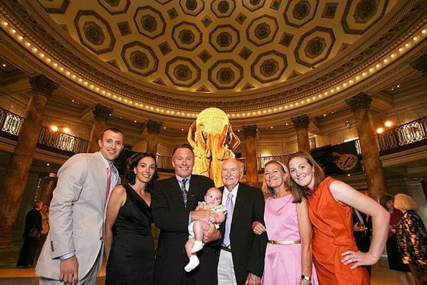 Four generations of the Haaga family pose in the Haaga Family Rotunda inside the renovated Natural History Museum. From left, Paul Haaga III, Catalina Haaga, Paul Haaga, Sienna Haaga, Daniel Sturt, Heather Haaga and Blythe Haaga enjoy the "Mingle With the Mammals" VIP reception to open the "Age of Mammals" exhibition.