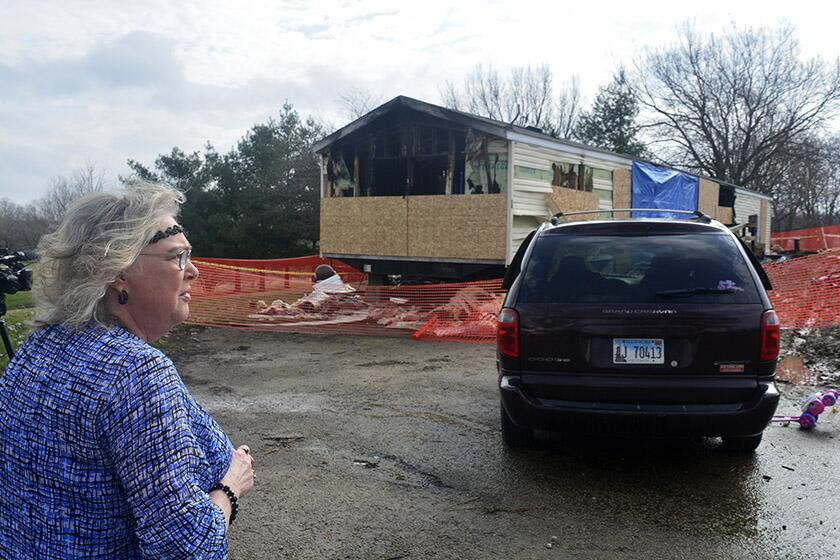 Marie Chockley, a resident of the Timberline Trailer Court near the village of Goodfield, Ill., surveys the damage to home on April 7 after a fire the night before. The fire killed a 1-year-old, two 2-year-olds, a 34-year-old man and a 69-year-old woman.