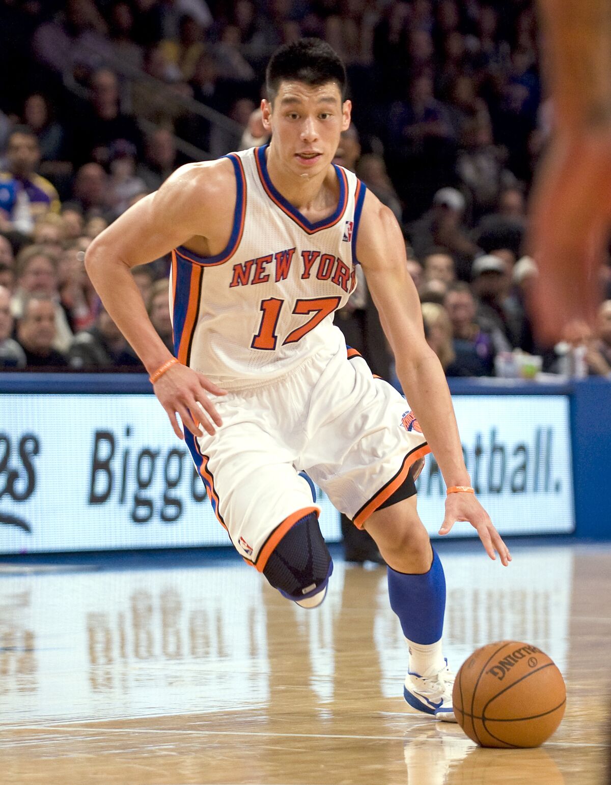 A New York Knicks player dribbles a basketball 