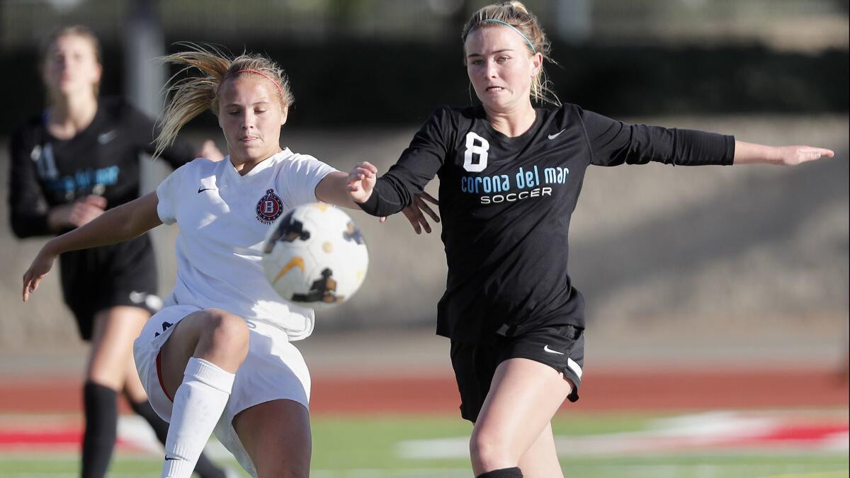 Corona del Mar High's Megan Chelf, right, shown playing against Beckman on Jan. 25, 2018, has 18 goals for the Sea Kings this season.