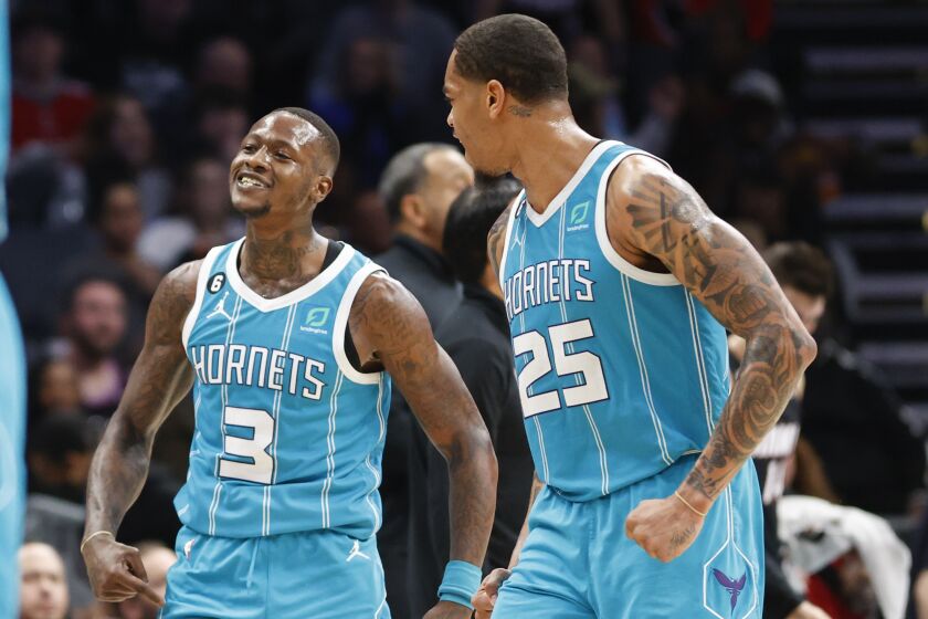 Charlotte Hornets guard Terry Rozier (3)reacts after making a 3-pointer as forward P.J. Washington (25) looks on during the second half of an NBA basketball game against the Miami Heat in Charlotte, N.C., Sunday, Jan. 29, 2023. Charlotte won 122-117. (AP Photo/Nell Redmond)