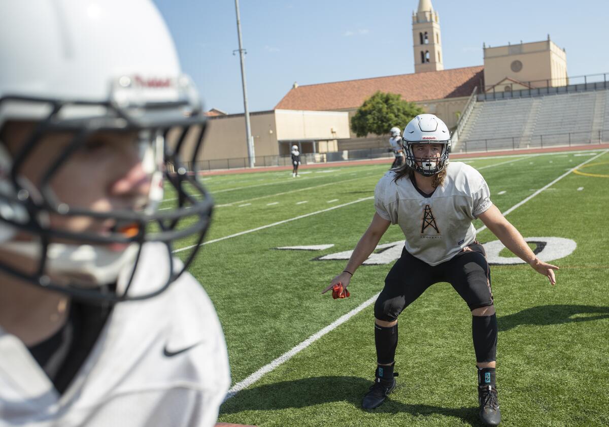 Christian Moore, right, shown working on drills during Huntington Beach's practice on Aug. 7, is a 6-foot-3, 235-pound linebacker and tight end committed to Kansas State.