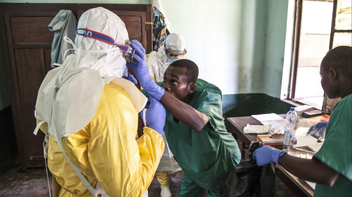 Medical staff don protective clothing before treating patients in an Ebola isolation ward in Bikoro, Democratic Republic of Congo.