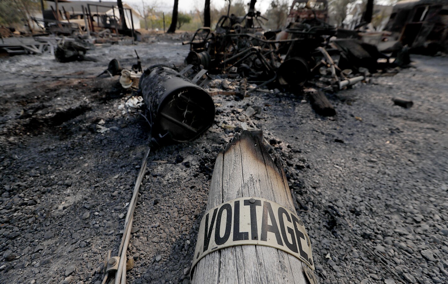 HEALDSBURG, CALIF. - OCT. 28, 2019. A charred utility pole lies amid burned machinery along Chalk Hill Road near Healdsburg on Tuesday, Oct. 29, 2019. (Luis Sinco/Los Angeles Times)