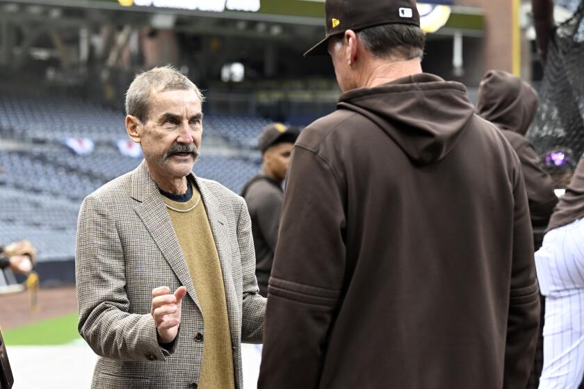 San Diego Padres owner Peter Seidler, left, talks with manager Bob Melvin during warmups before a baseball game against the Colorado Rockies in San Diego, Thursday, March 30, 2023. (AP Photo/Alex Gallardo)