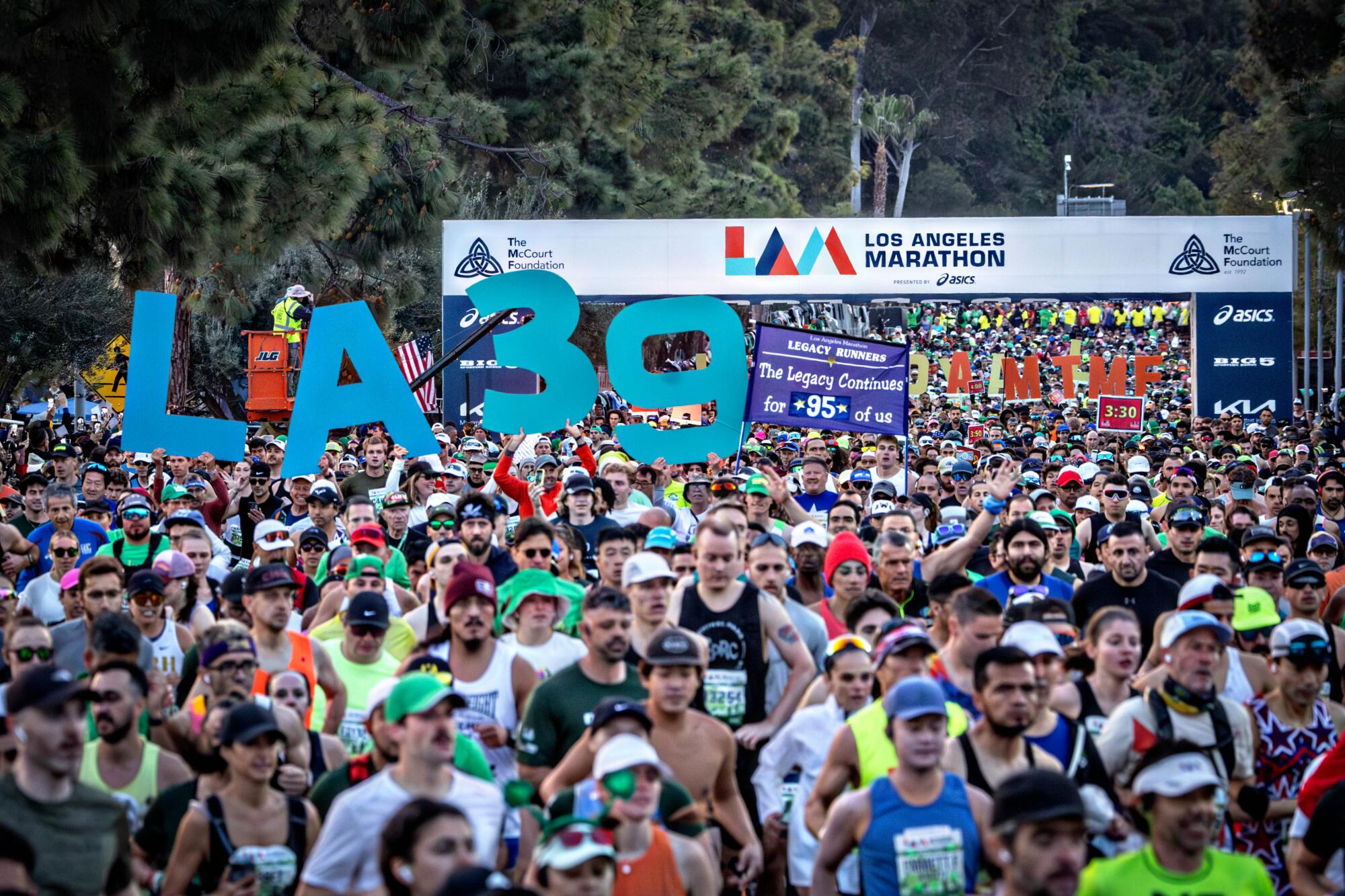 Runners start the 39th Los Angeles Marathon at Dodger Stadium on Sunday.