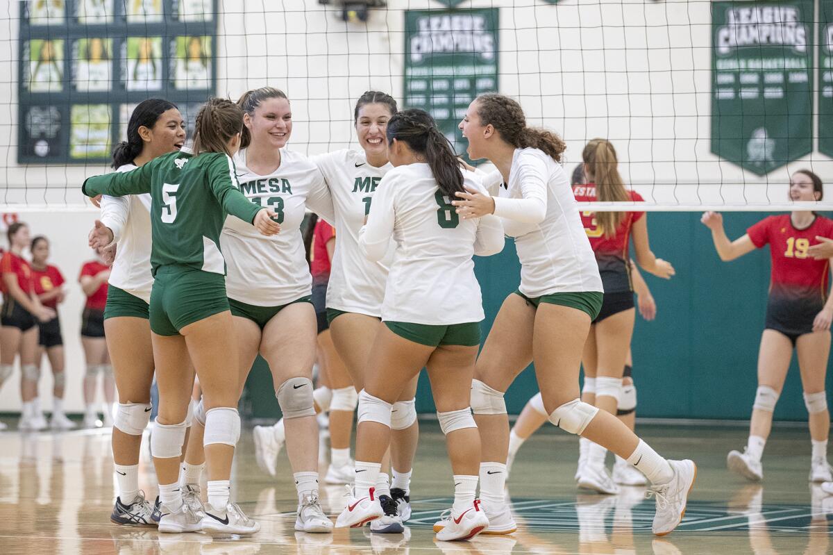 Costa Mesa celebrates a point during the second Battle for the Bell match against Estancia on Tuesday.