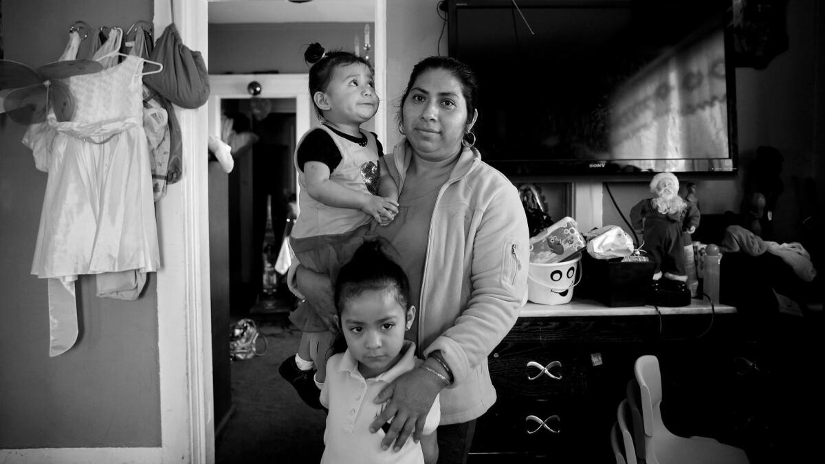 Cornelia Martinez, with some neighborhood children. She and her partner, Freddy Velasquez, have lived in their one-bedroom apartment since 1999 with their two daughters. She says she was pressured to leave after the defendants purchased the building, according to a declaration.