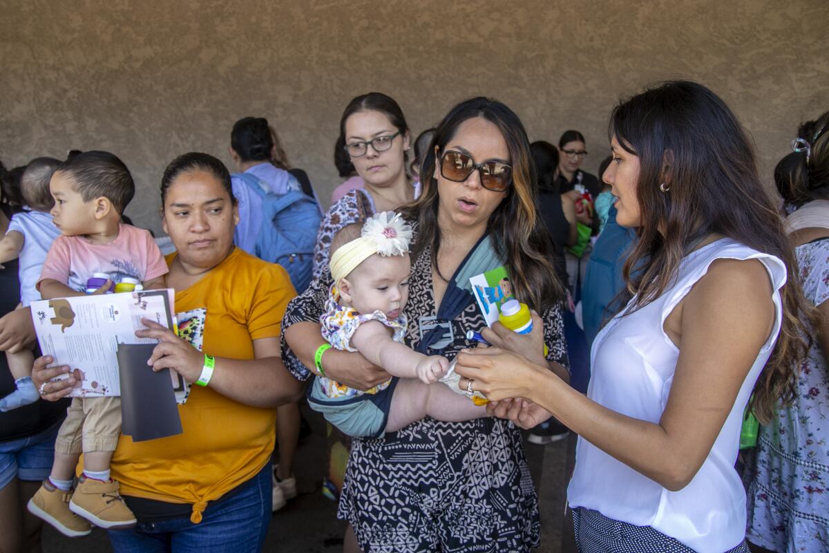 Kelsey Bonnet discusses lactation tips with moms outside the MOMS Orange County building in Santa Ana.