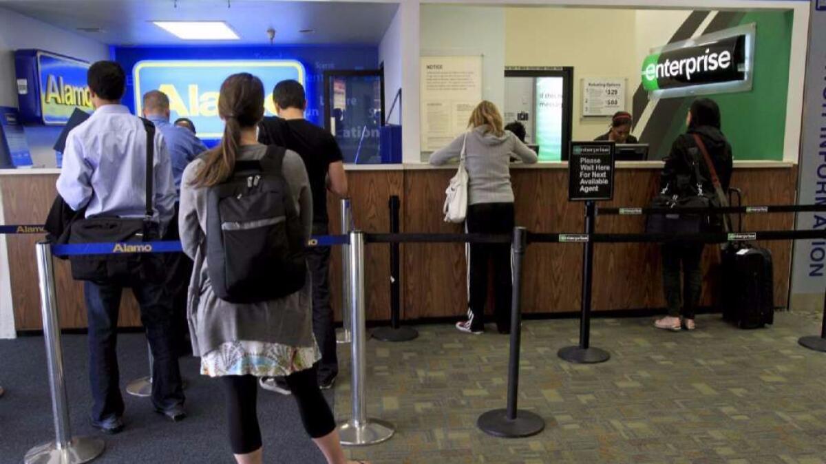 The Enterprise car rental counter at the Bob Hope Airport in Burbank is seen on Jan. 25, 2011. Satisfaction with the car rental industry is up but primarily because prices have dropped an average of $11 per day, according to J.D. Power.