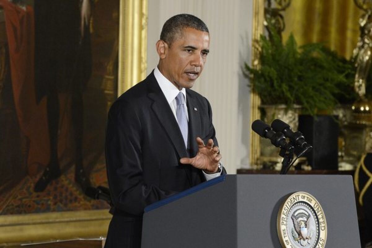 President Barack Obama delivers remarks in front of a portrait of George Washington.
