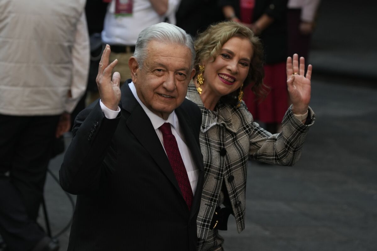 FILE - Mexican President Andres Manuel Lopez Obrador and wife Beatriz Gutierrez Muller wave during a state visit, at the National Palace in Mexico City, Jan. 11, 2023. Lopez Obrador said Thursday, Feb. 2, 2023, that after his term ends in September 2024, he will totally withdraw from politics. (AP Photo/Fernando Llano, FILE)