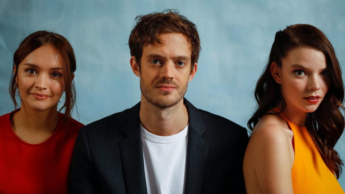 Director Cory Finley, center, is photographed with his lead actresses Olivia Cooke (in red) and Anya Taylor-Joy, from the film, "Thoroughbreds," at the London Hotel in West Hollywood.