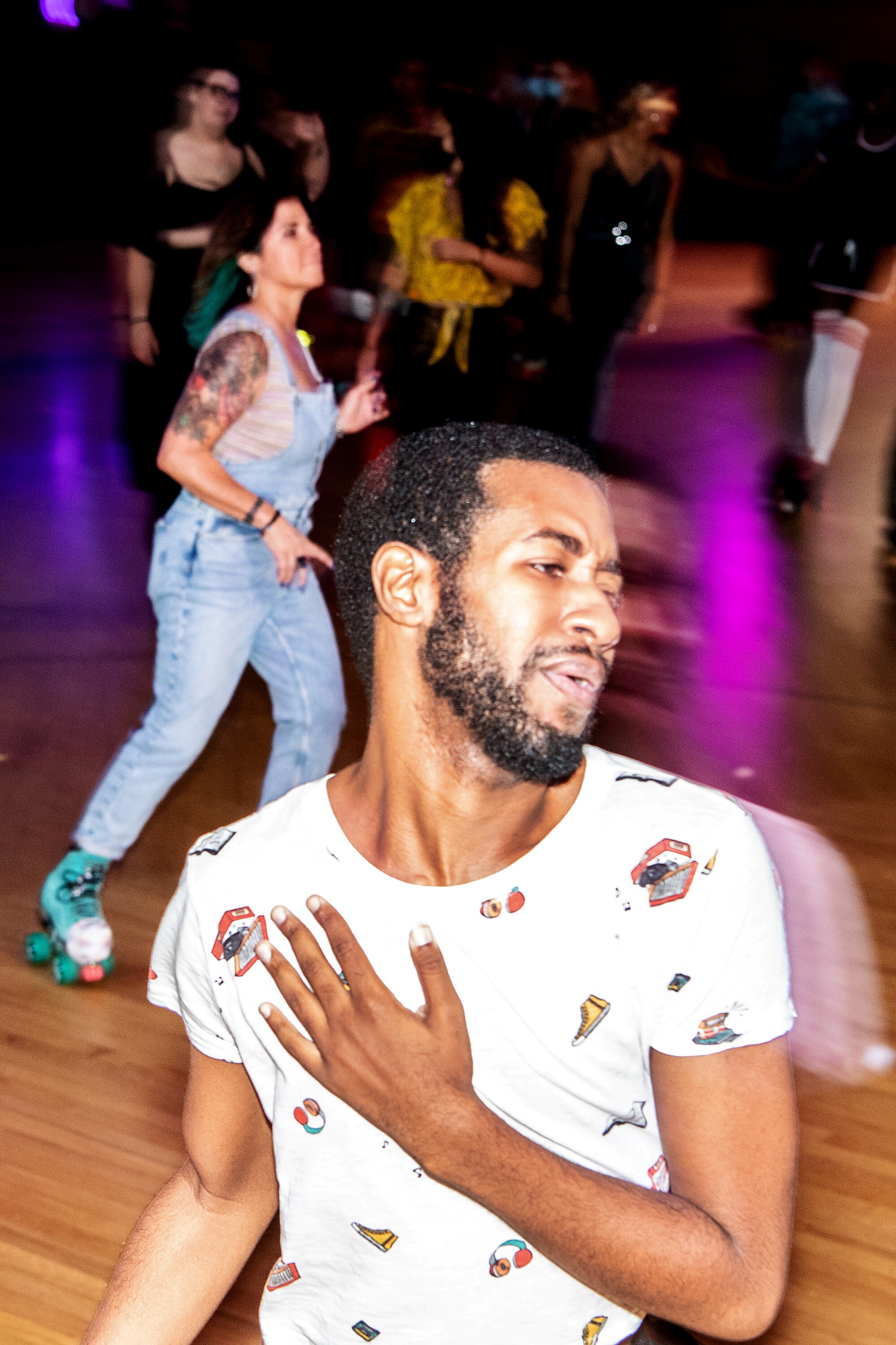 A person holds their chest with feeling while listening to music and skating.