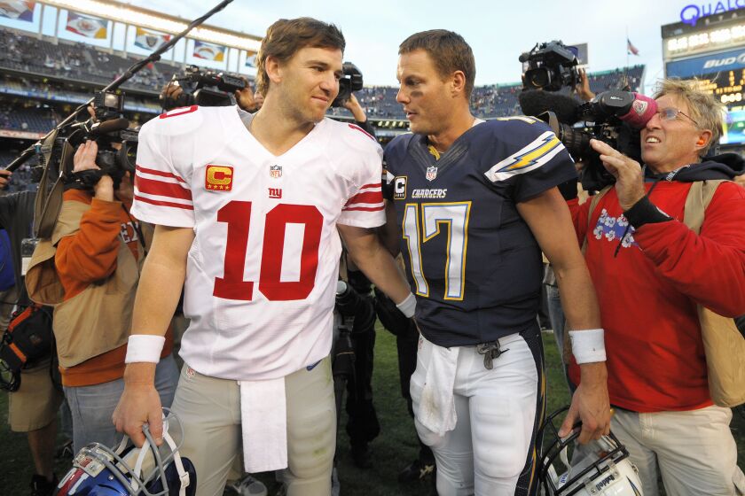 Eli Manning, left,  and Philip Rivers were traded for each other in the 2004 draft.