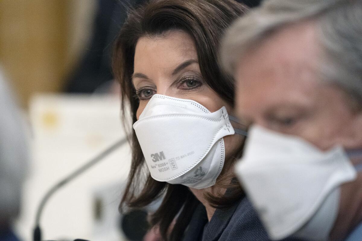 Gov. Kathy Hochul of New York wears a mask during a meeting.
