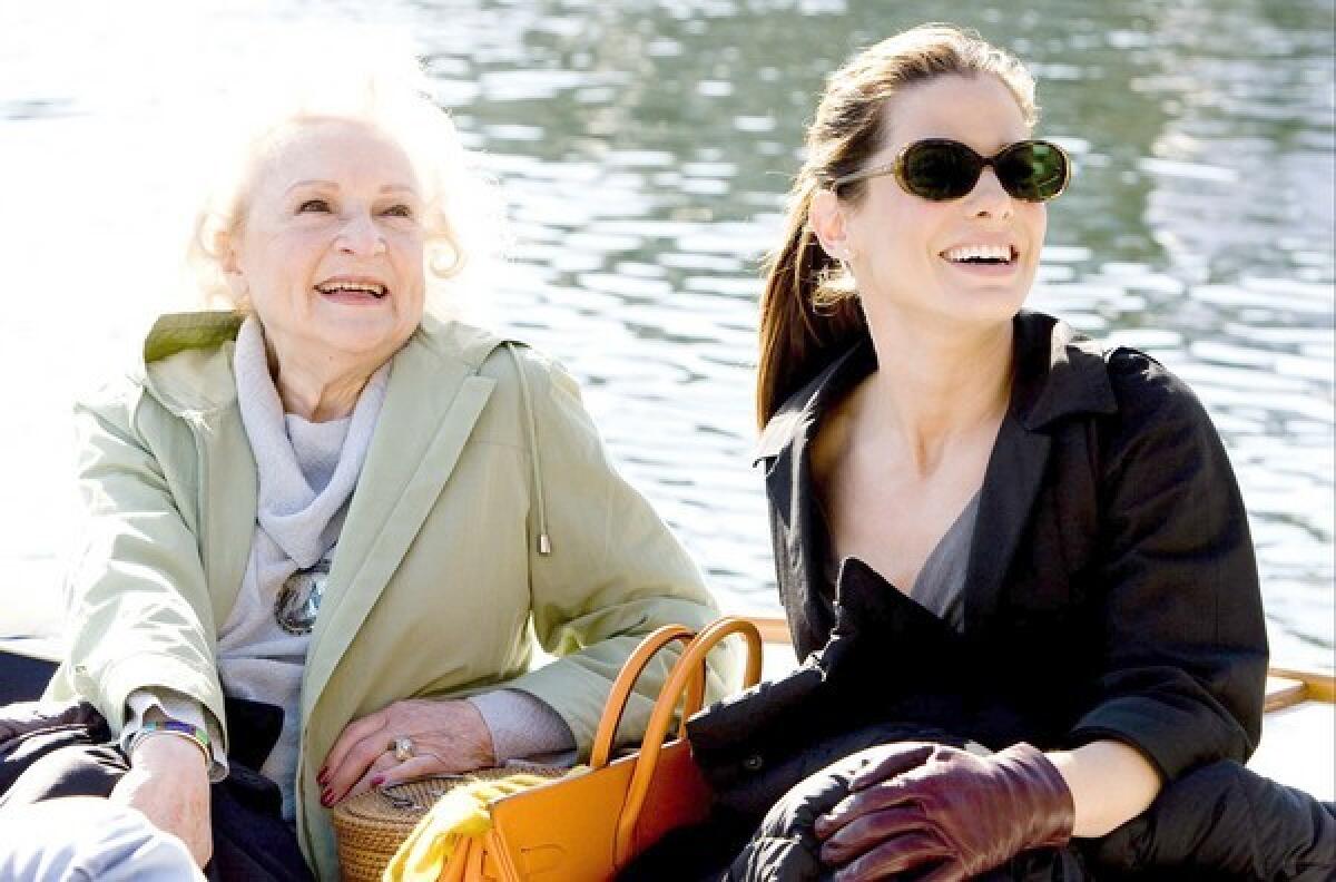 Betty White, left, and Sandra Bullock sit at the waterfront in the rom-com "The Proposal."