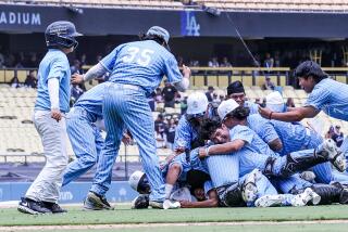 Carson players celebrate after a 3-1 win over Banning in the City Section Division I final at Dodger Stadium.