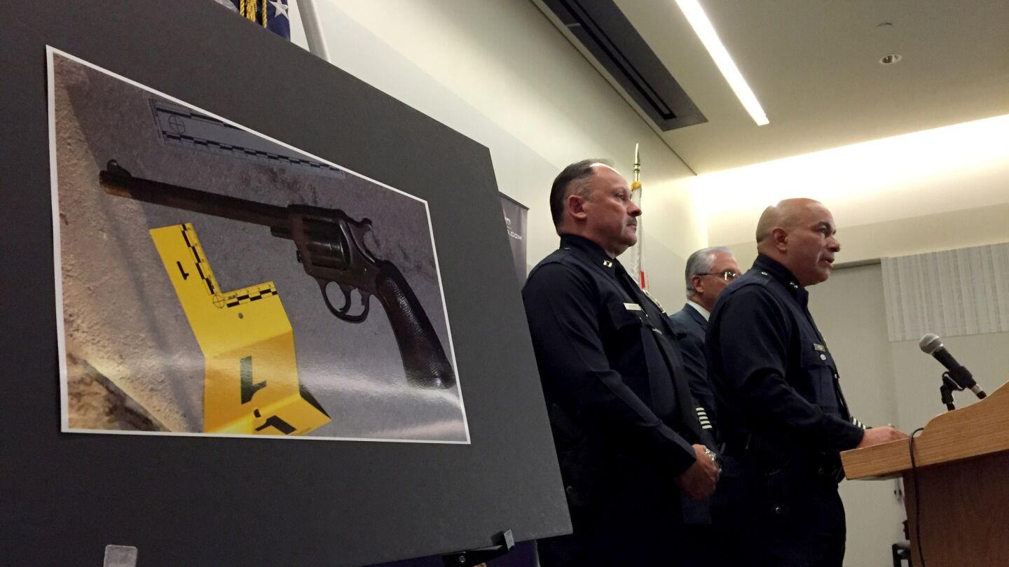 A photograph of a gun, allegedly carried by Jesse Romero, 14, who was shot dead by Los Angeles police in Boyle Heights, is displayed at a news conference at LAPD headquarters Wednesday Aug. 10, 2016. At right is Deputy Chief Robert Arcos.