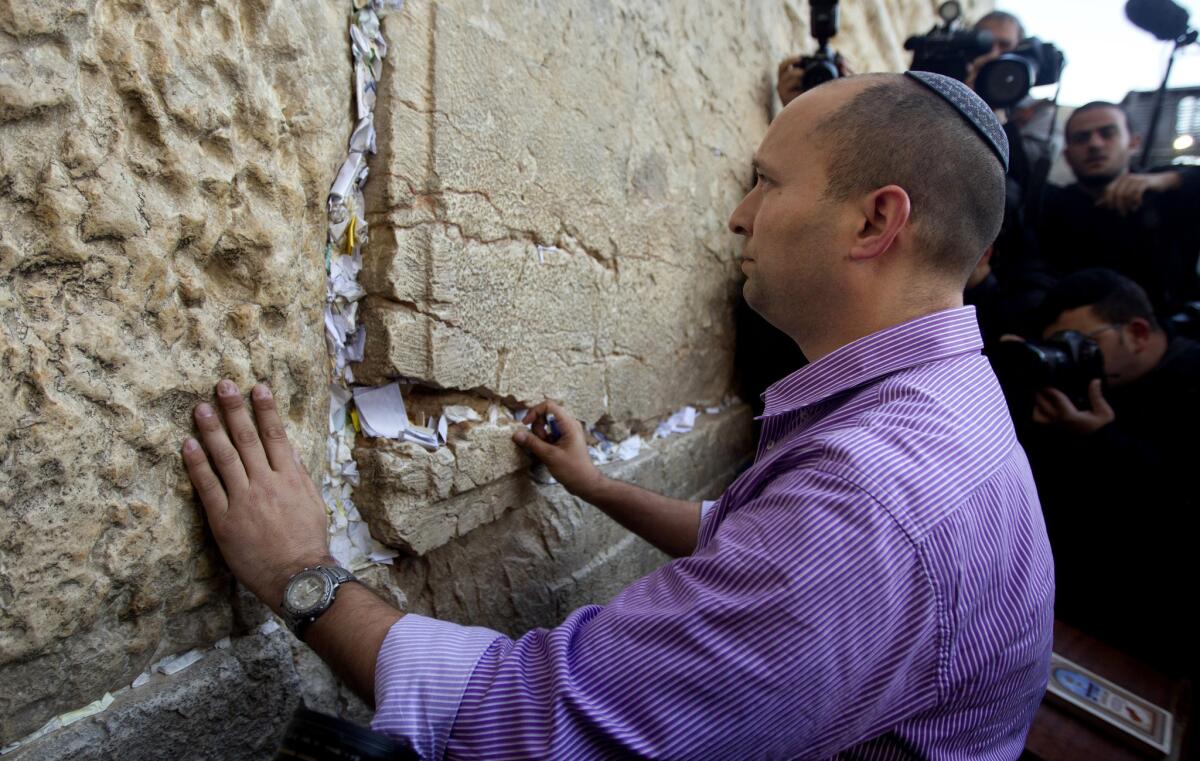 In this file photo, Naftali Bennett, head of the Jewish Home party, touches the stones of the Western Wall, the holiest site where Jews can pray in Jerusalem's Old City. The idea of Palestinians establishing a state has "reached a dead end," Bennett said Monday.