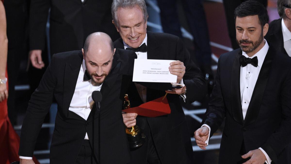 Jordan Horowitz, producer of "La La Land," left, shows the envelope revealing "Moonlight" as the true winner of best picture at the 2017 Oscars in Los Angeles.