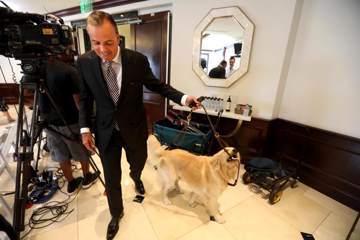 Rick Caruso with his dog, Hudson, last week at the Grove.